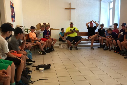 Coach Forrester leads a devotional with the campers.